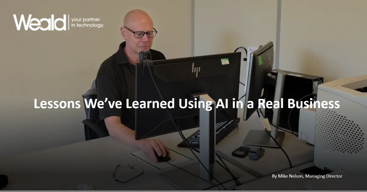 Mike Nelson, Managing Director of Weald IT, working at his desk discussing the practical use of AI in business.